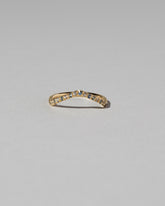 Gold Pavé Blue Sapphire Low Peak Band on light color background.