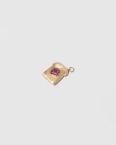 Closeup details of the Jelly Toast Charm on light color background.