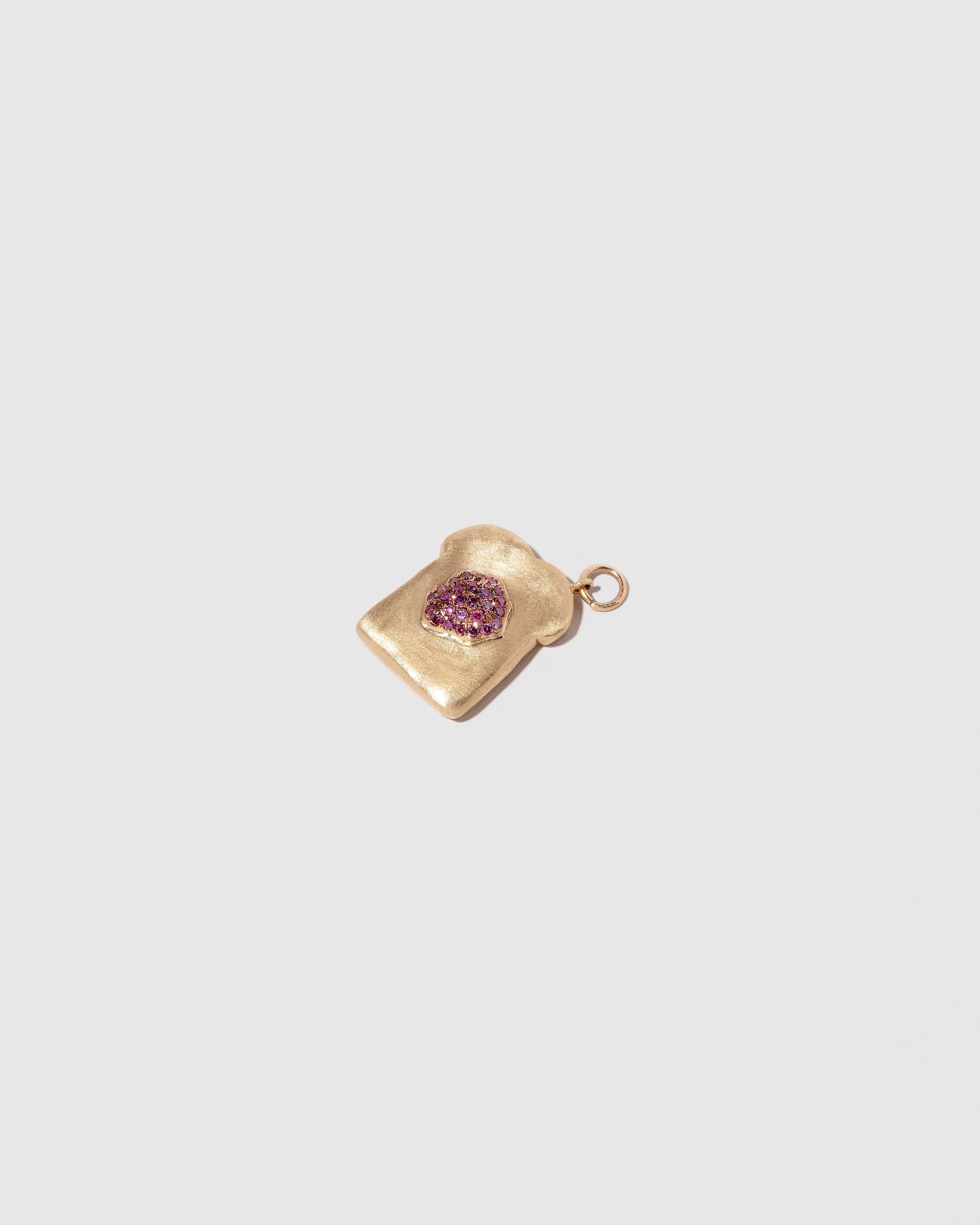 Closeup details of the Jelly Toast Charm on light color background.