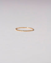 Gold 1.5mm Etched Lines Band on light color background.