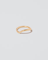 View from the side of the Gold Solid Square Wire Left Slump Band on light color background.