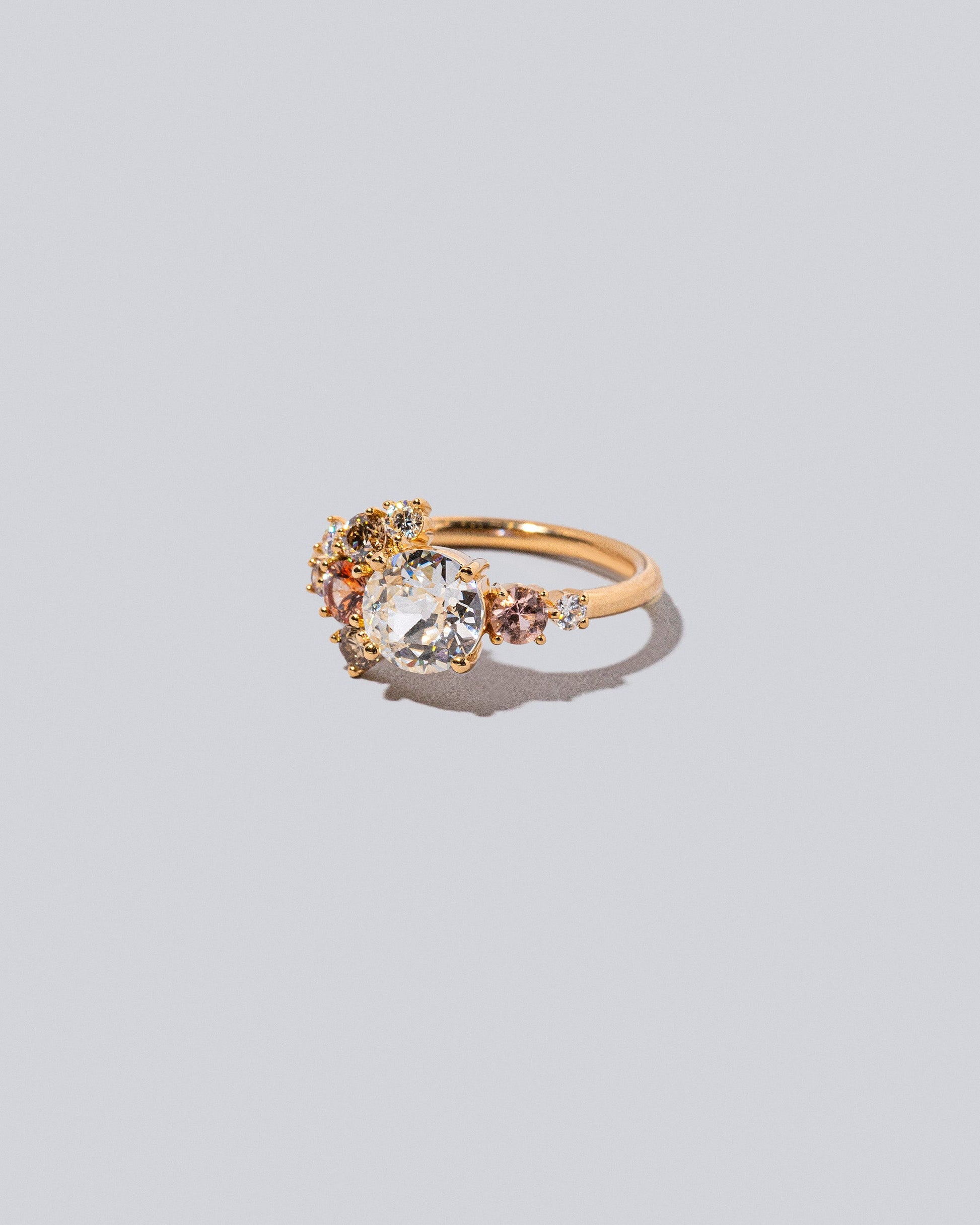 Product photo of the Peach Vega Ring on a light color background. 