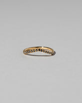 Gold Pavé Black Diamond Low Peak Band on light color background.