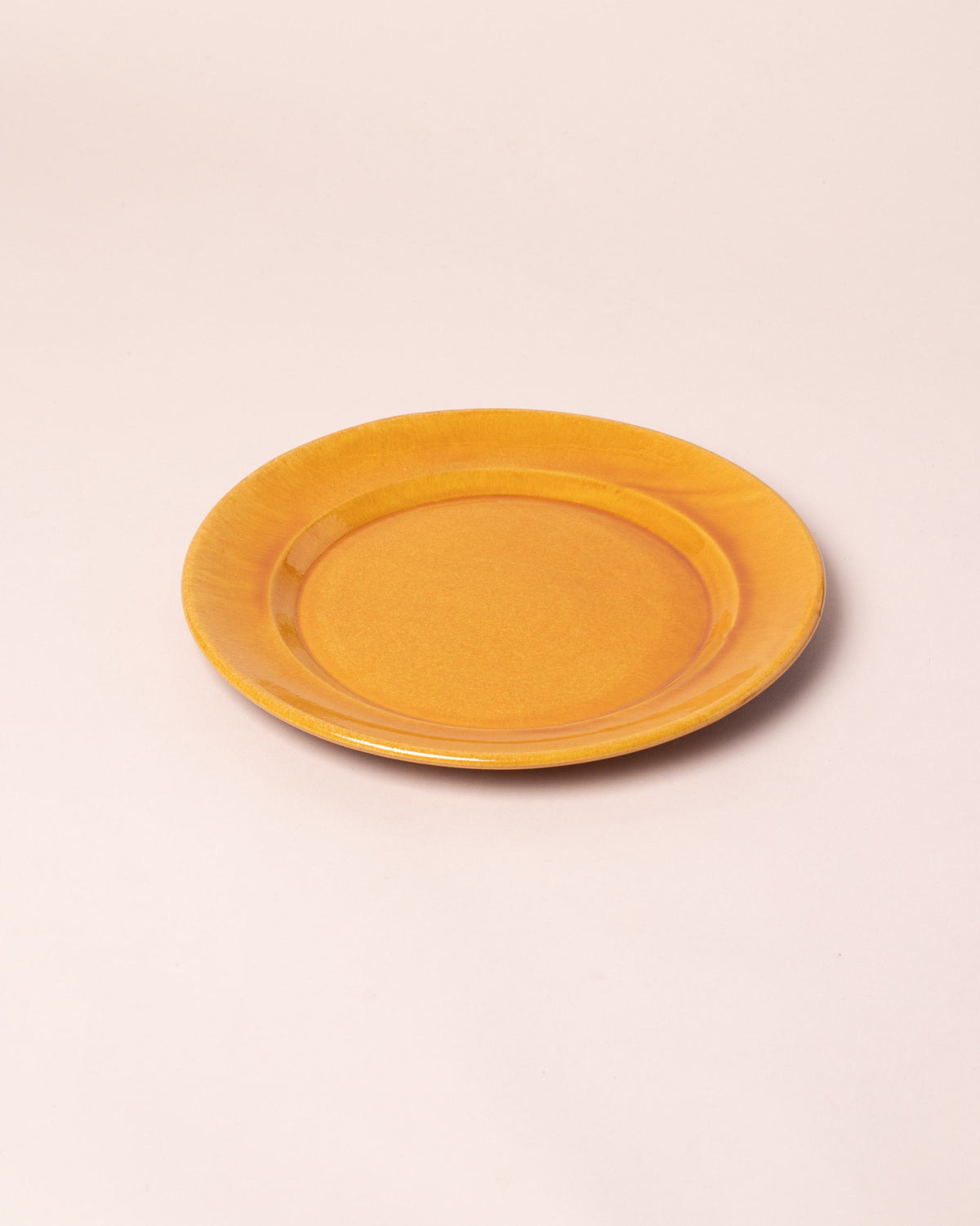 Closeup details of the La Ceramica Vincenzo Del Monaco Caramel Yellow Large Dish on light color background.