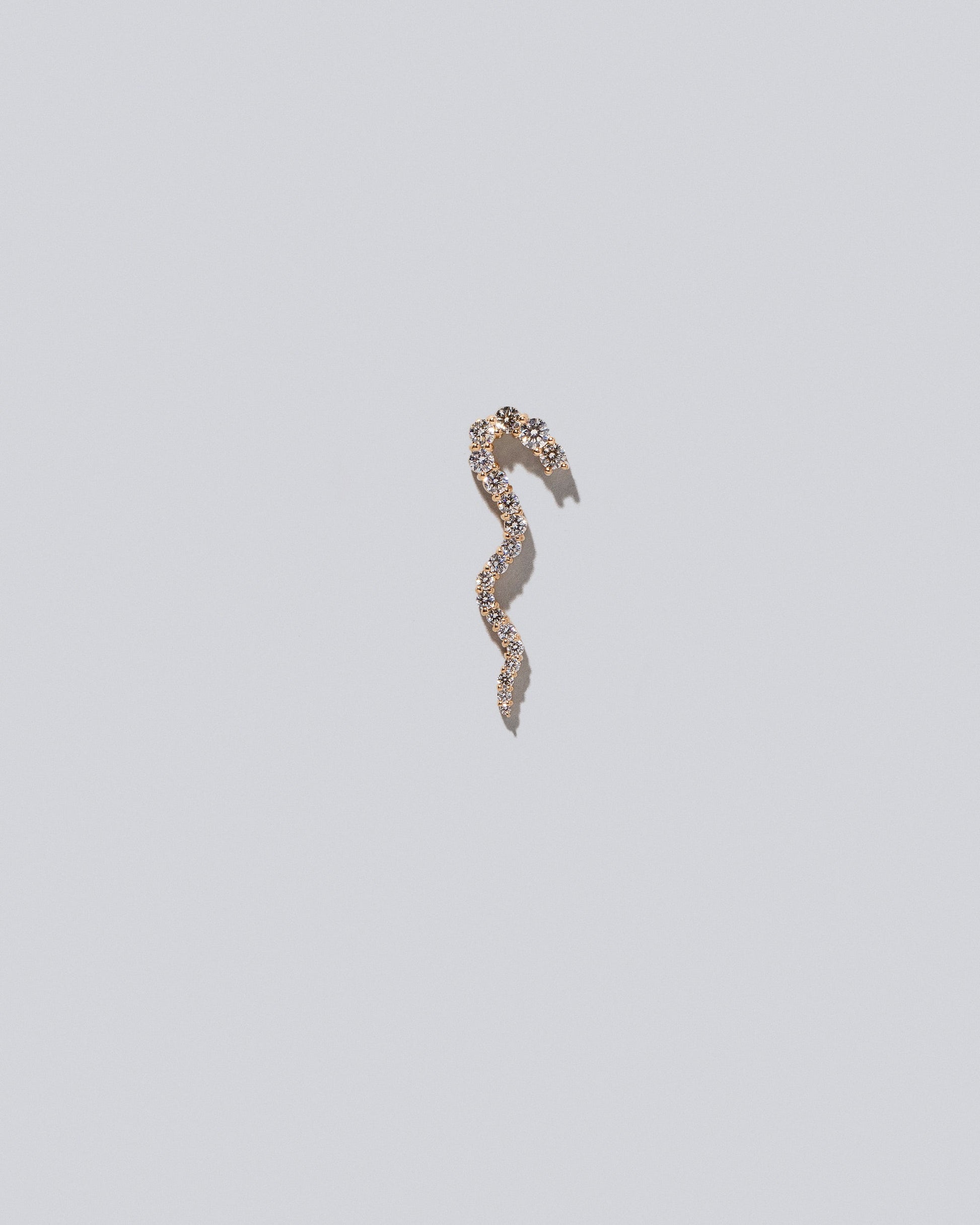 Gold White Diamond Right Ripple Wave Earring Single on light color background.