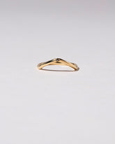 Gold Single Stone Black Diamond Low Peak Band on light color background.