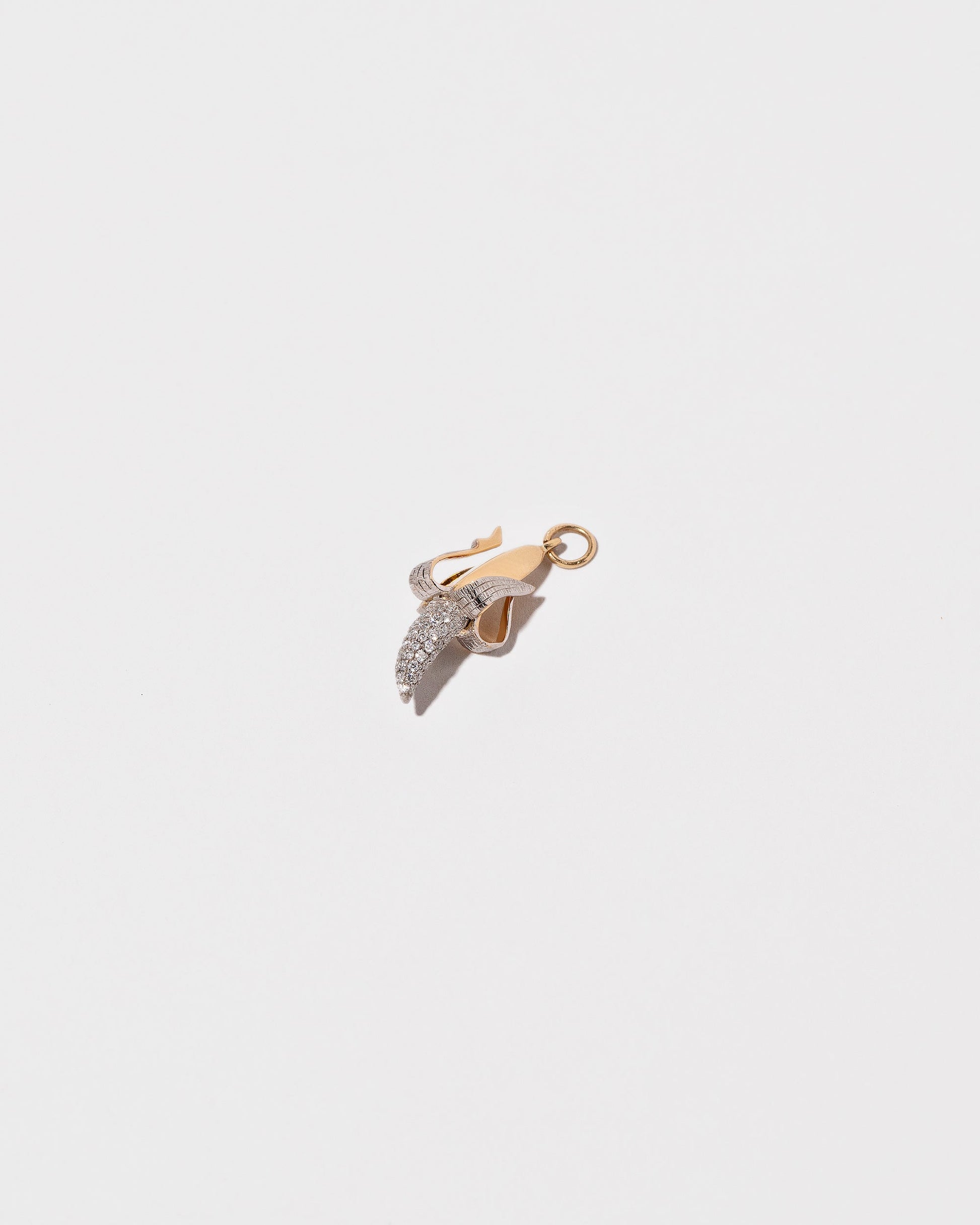 View from the side of the Peeled Banana Charm on light color background.