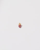 Diamond & Ruby Pavé Strawberry Charm on light color background.
