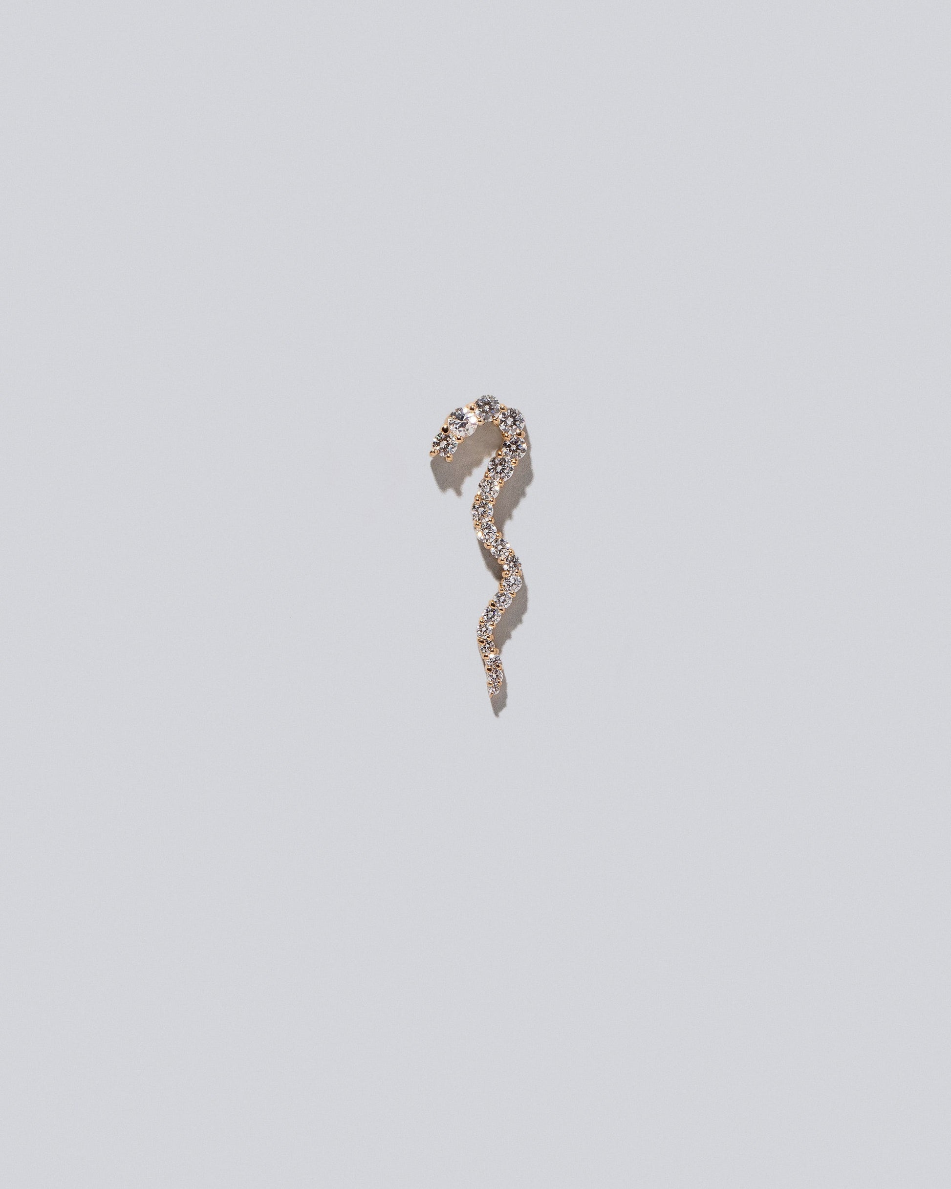 Gold White Diamond Left Ripple Wave Earring Single on light color background.