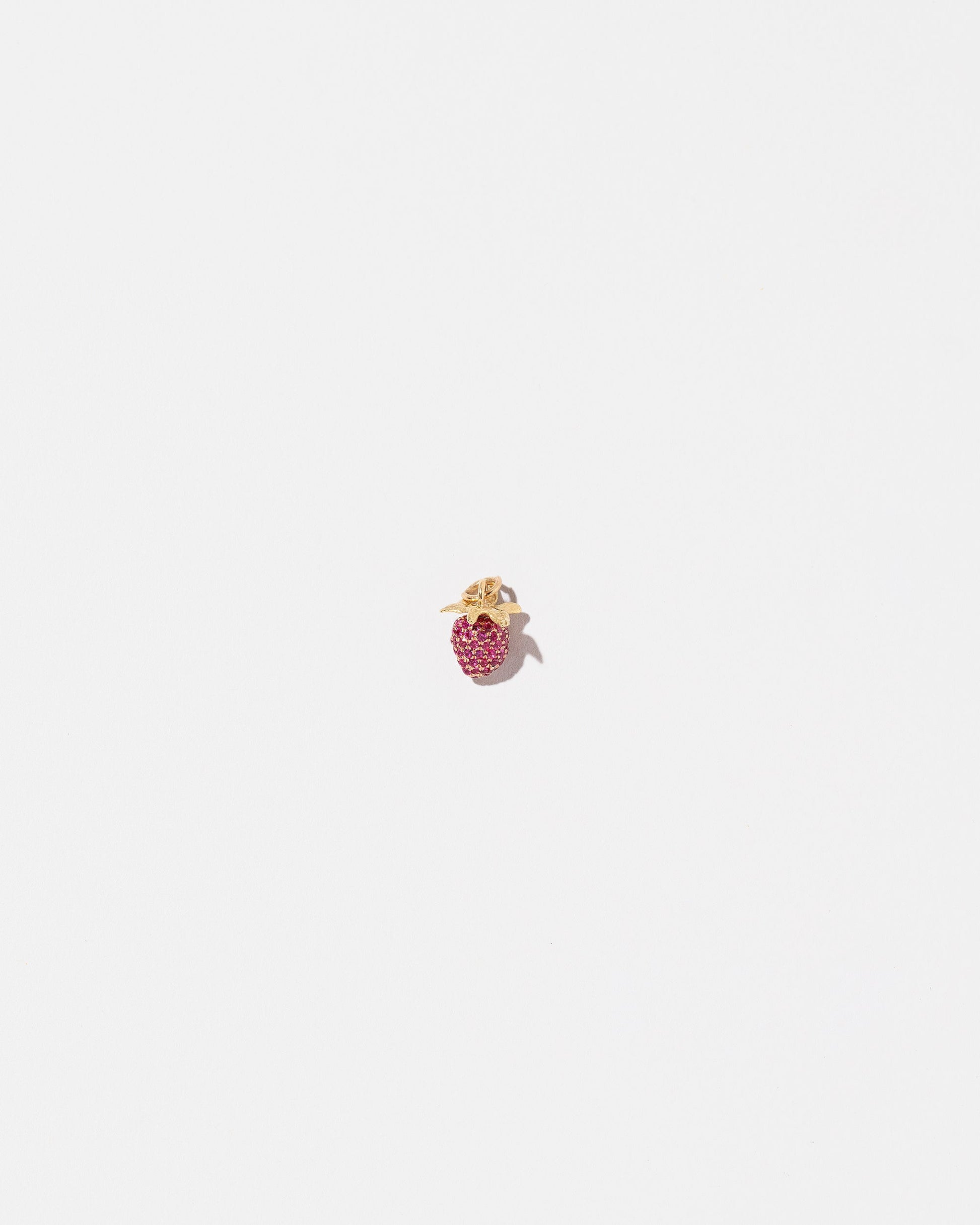 Ruby Pavé Strawberry Charm on light color background.