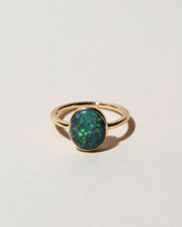 Australian Black Opal Ring on light color background.