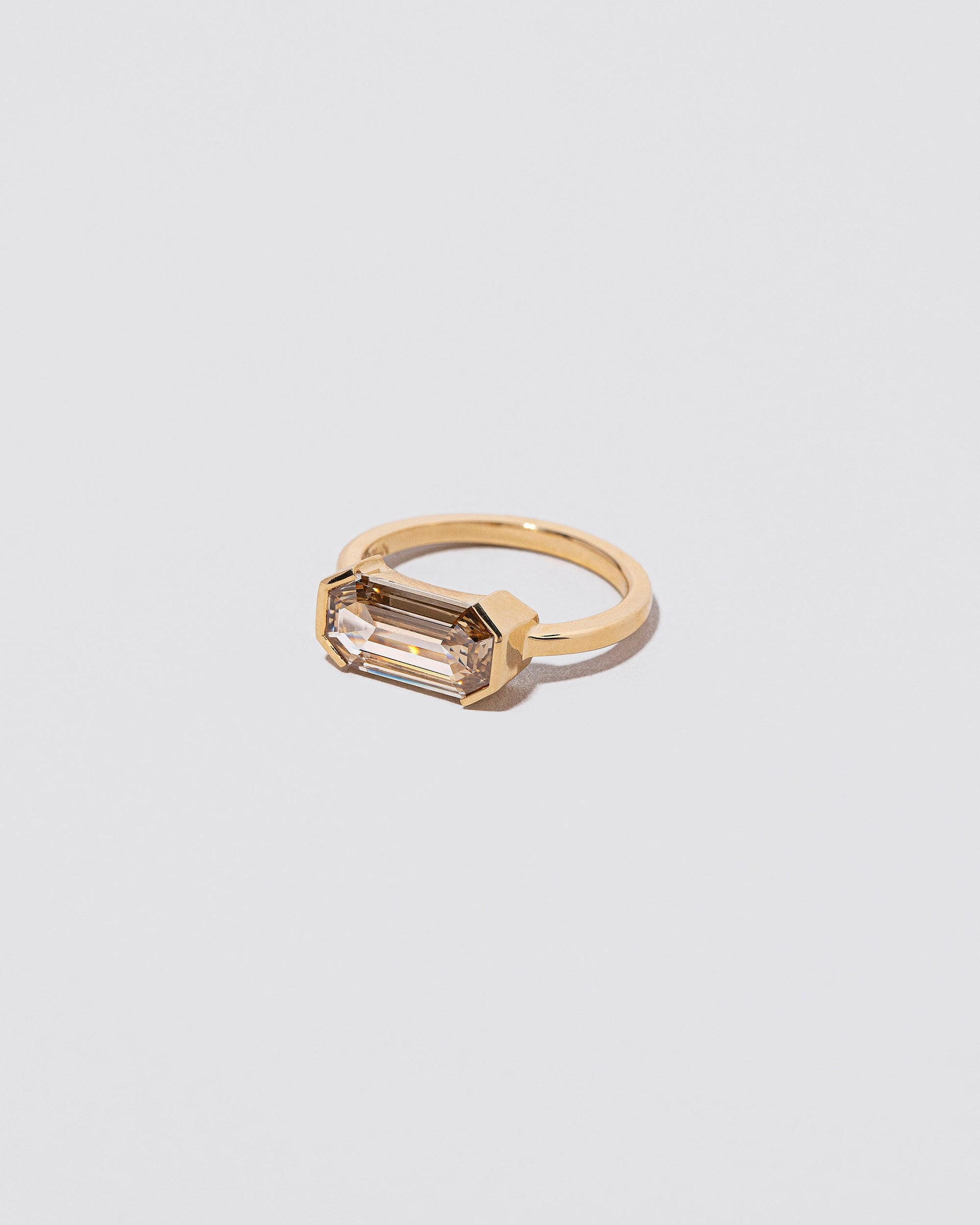View from the side of the Book of Love Ring on light color background.