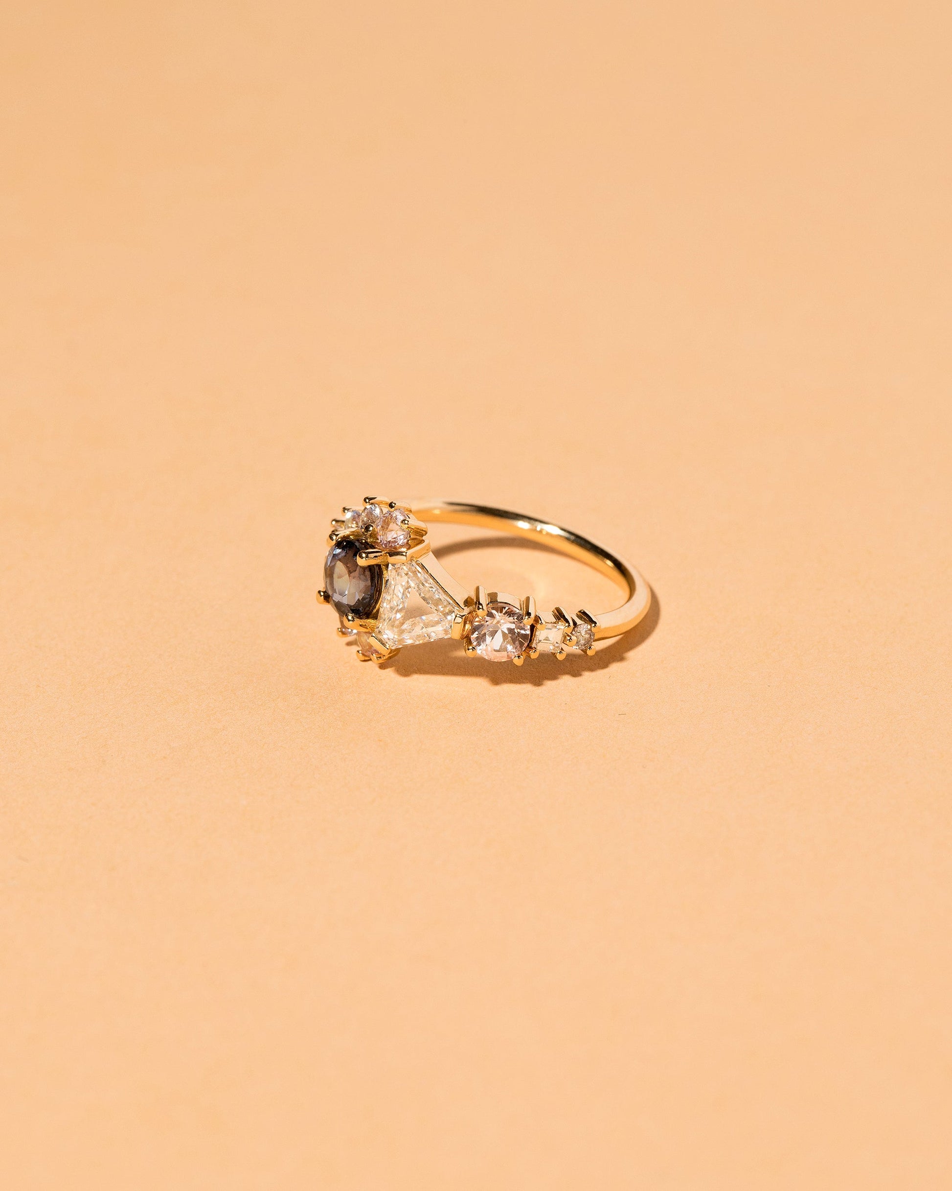  Diamond, Spinel & Sapphire Cluster Ring on light color background.