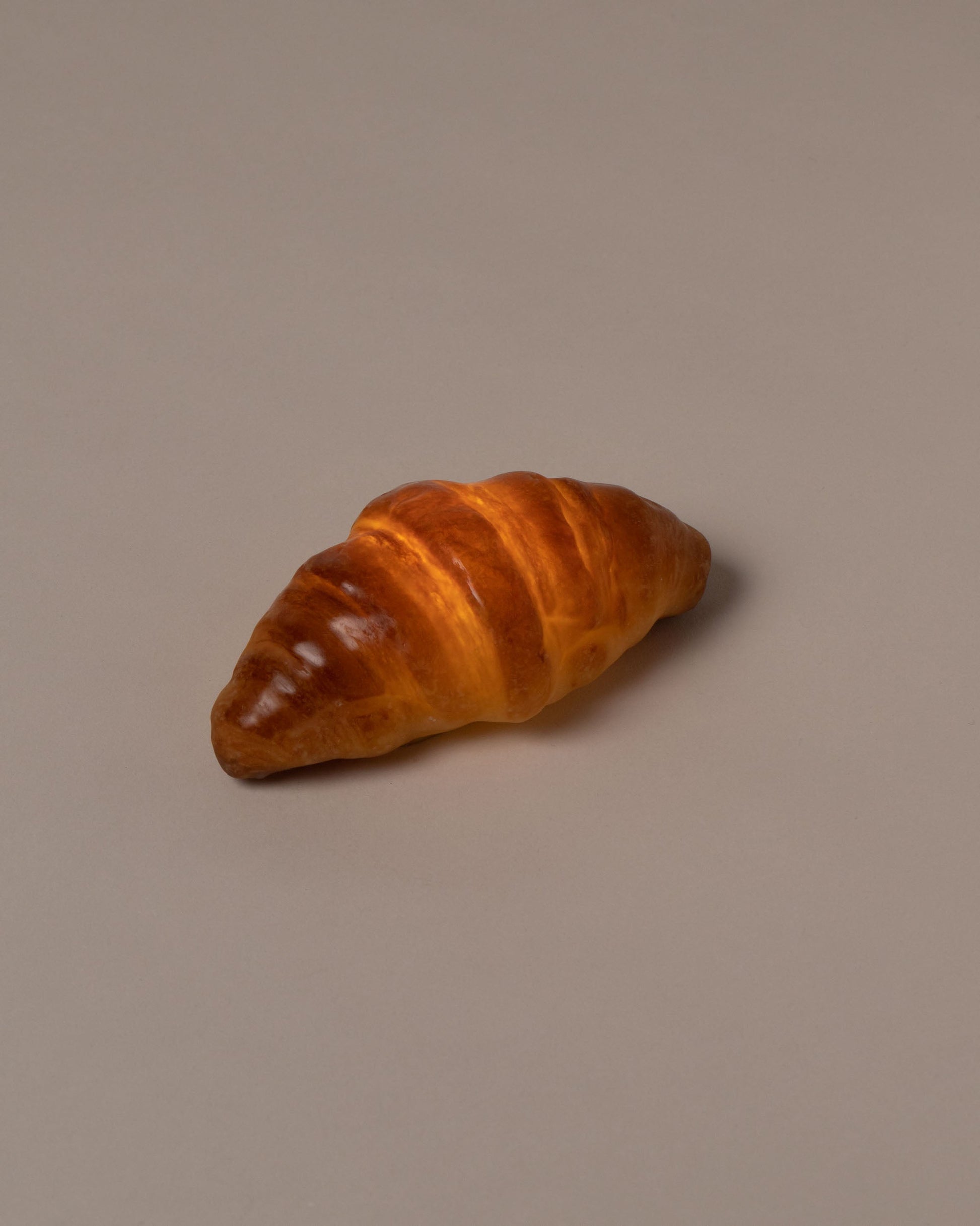 In-use detail view of the Pampshade Croissant Lamp on light color background.