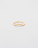 Gold Square Wire Mini Curve Band on light color background.