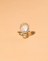 Moonstone & Diamond Cluster Ring on light color background.