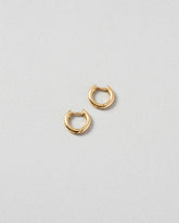 Gold Huggies Solid Snack Hoops on light color background.