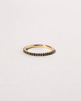 Closeup details of the Gold Black Diamond Gear Edge Band on light color background.
