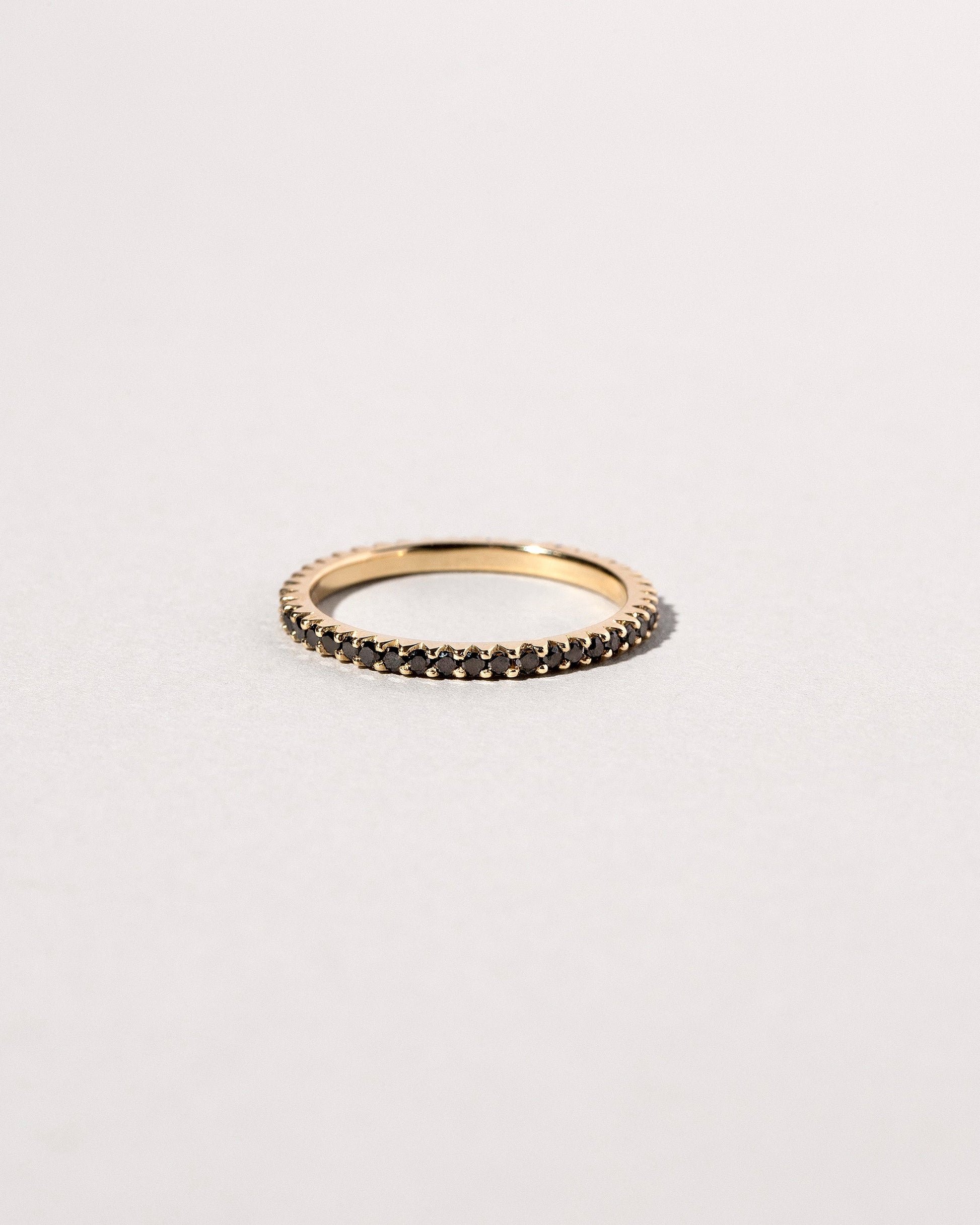 Closeup details of the Gold Black Diamond Gear Edge Band on light color background.