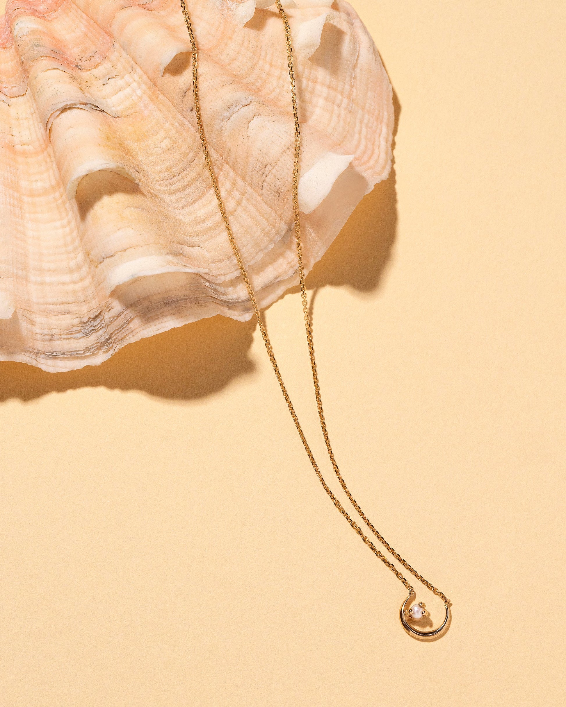 Moon Ray Necklace on light color background.