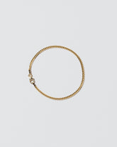 2.4mm Curb Chain Bracelet on light color background.