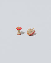 Red Apple Core Charm and Red Apple Halved Charm on light color background.